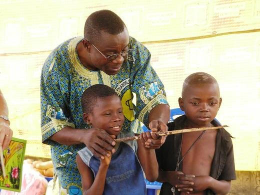 Theo helping kids perform the skit of “the little boy learning how to hunt”, from the STEPS Program