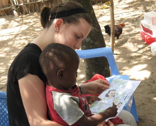 Natalie helping an orphan boy to color