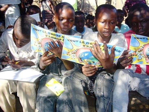 Orphaned kids reading Christian posters