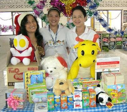 Rose, a member of TFI, distributing Toys at Christmas time in Thailand.