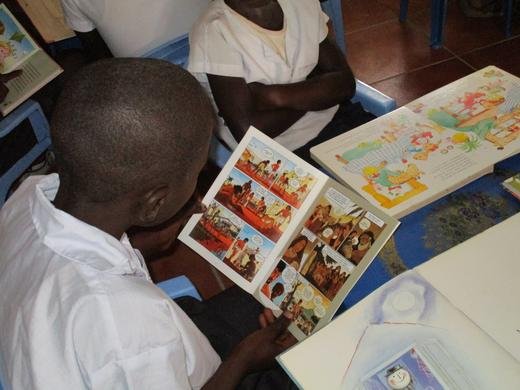 Child reading The Picture Bible in newly set up library