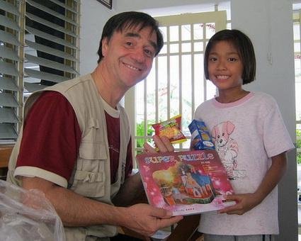 Victor, a member of TFI, distributing toys in Thailand.