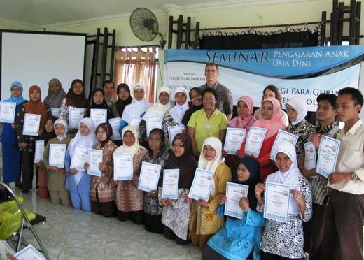 TFI members Daniel Angel and Sharon with the teachers who received their Graduation Certificates after completing the early learning seminar