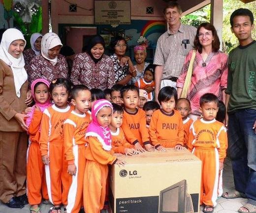 TFI volunteers Daniel and Sharon in Kulong Progo in central Java donating TV sets as a follow up to their earlier teachers educational seminars.