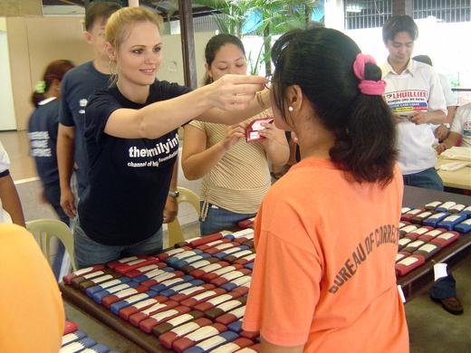 Debbie assisting an inmate with her new pair of eyeglasses, Philippines