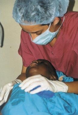 Elene comforts a child before eye surgery