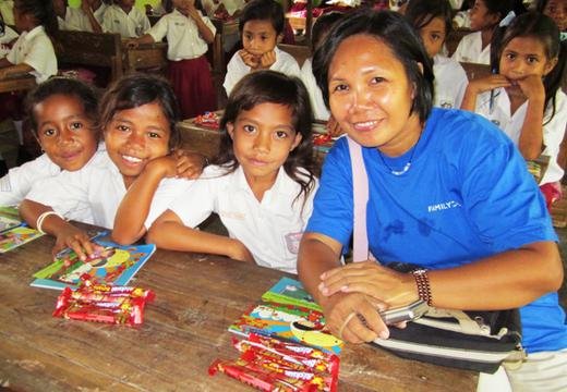 TFI volunteer, Esther, donating school materials to children in east Indonesia.