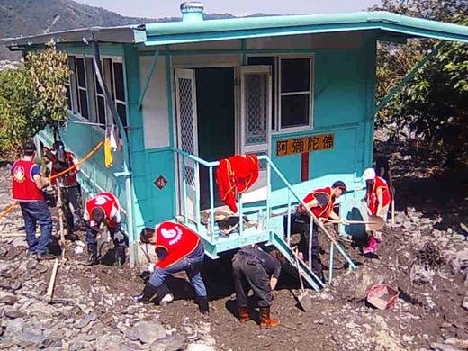 Family International team working to clear a house in a village that had been buried under a mudslide