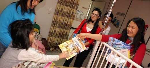 Family volunteers distributing sponsored Activated mags to children in hospital, Taiwan