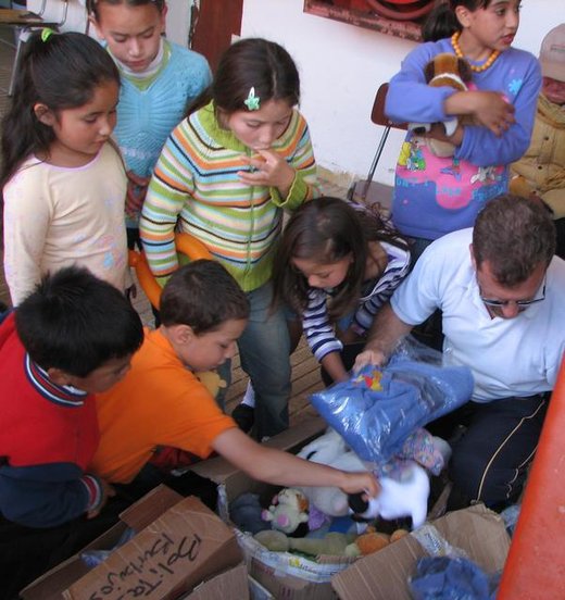 Felipe passing out gifts and warm pajamas to children affected by the earthquake