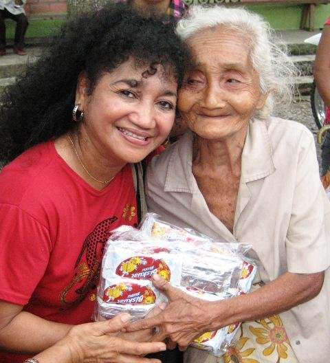 Francis, a volunteer with the Family International, giving food to those affected by a recent natural disaster.