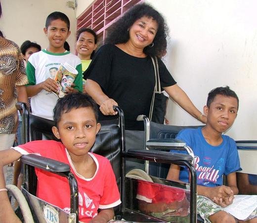 TFI volunteer, Francis, with two handicapped children at an orphanage on Ambon Island, East Indonesia.