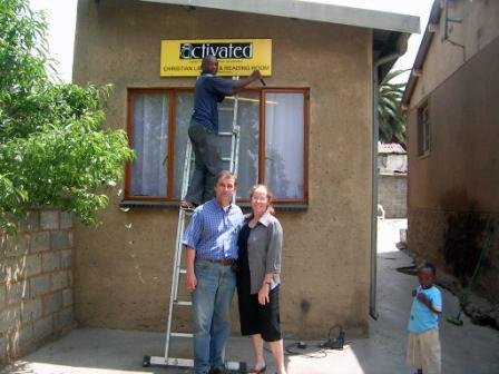 Josef and Janet in front of the Library as they put up the sign