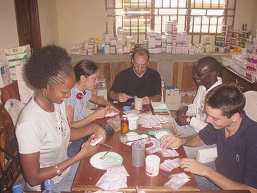 Family volunteers (from left) Joy, Mary, Jan, Charles, and Stephan, carefully package prescriptions in the dispensary. 