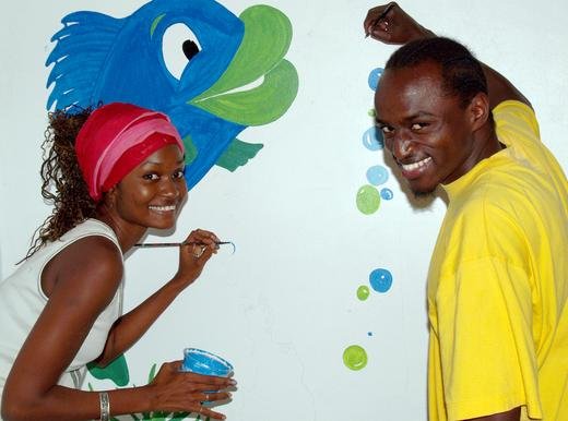 Malaika and volunteer JohnMary painting a mural at Little Angels orphanage, Uganda
