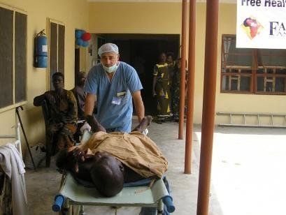Volunteer Simon moving a patient into surgery