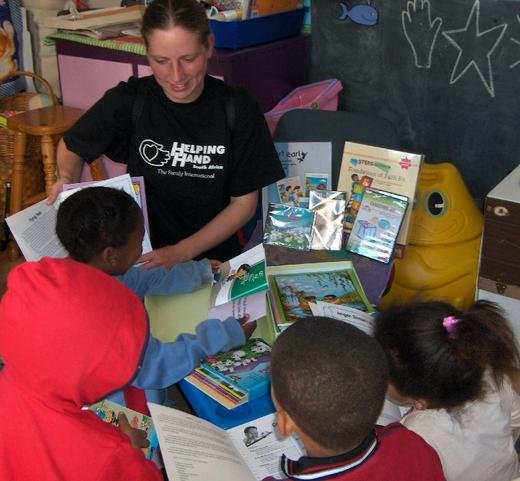 Helping Hand, Cape Town: Michelle looks at the donated educational material with the children