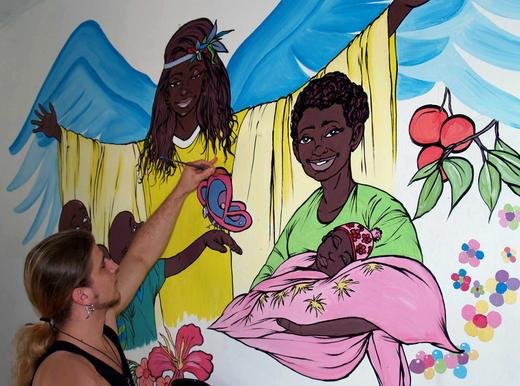 Mike painting a mural at Little Angels orphanage, Uganda