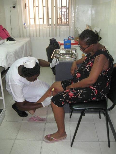Nurse dressing a patients wound