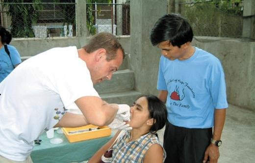Gabriel Tangalin (R) from The Family assists Dr. Casper Boelsgaard from Denmark.