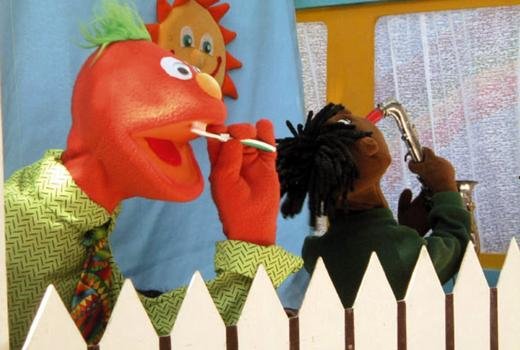 Puppets Jack (with toothbrush) and Ben (on saxophone) teach dental hygiene through the song “Brushy, Brushy,” from The Family’s Treasure Attic CD/video series for children.