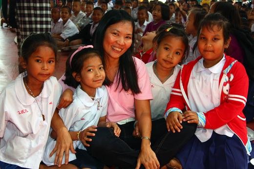 Pat with happy orphans after a performance, Thailand