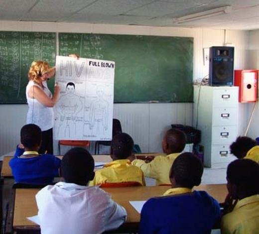 Rachel holding up a chart illustrating HIV positive and AIDS