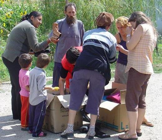 Family volunteers distributing donated shoes and other aid, Serbia