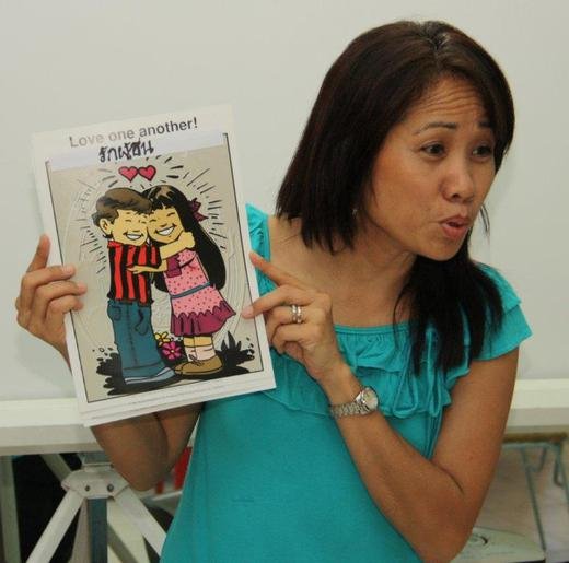 TFI member Sunny teaching the children at the Thonburi slum daycare about manners.