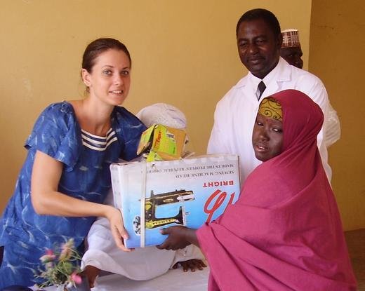 One of the attendees receives her donated sewing machine