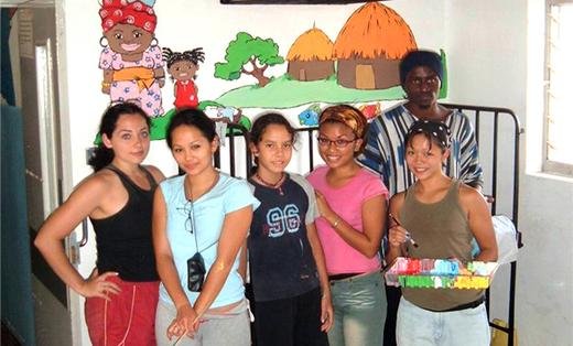 Nyx Martinez, (third from right) with other Family volunteers painting murals at a children's hospital in Uganda