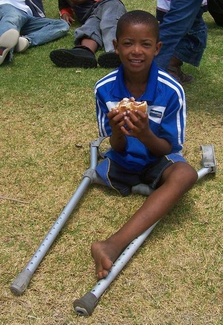A little boy with a big burger