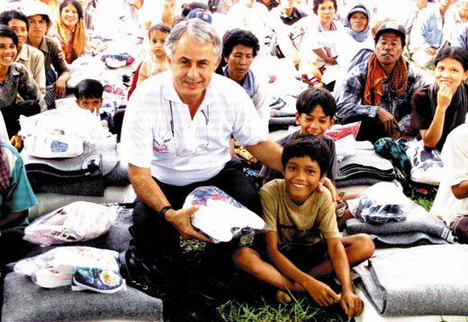 Tommy, with brothers Ponlho and Ponleu (back), amid the sea of donated goods and grateful recipients.