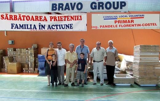 In Romania, the vice mayor of Voluntari poses along with staff and Family volunteers with some donated bathroom items 