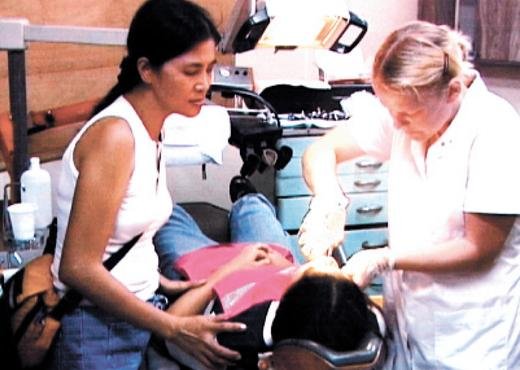 <strong>Team effort. </strong> Marie from The Family assists Lotte at the free dental clinic held in Cebu, Philippines.