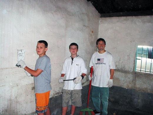 <strong>Many hands make light work.</strong> Tony, Bobby, and Johnny prepare to paint a house that was still inhabitable.