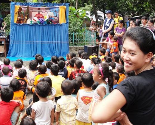 Young people from TFI performing their puppet show for underprivileged children at a medical clinic in Kebon Nanas in Jakarta.