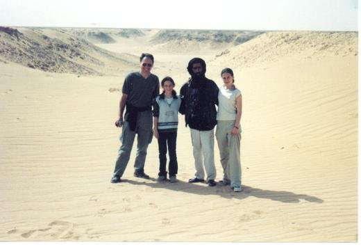 Victor, Katrina, their driver, and Sara pose for a photo just outside one of the camps. 